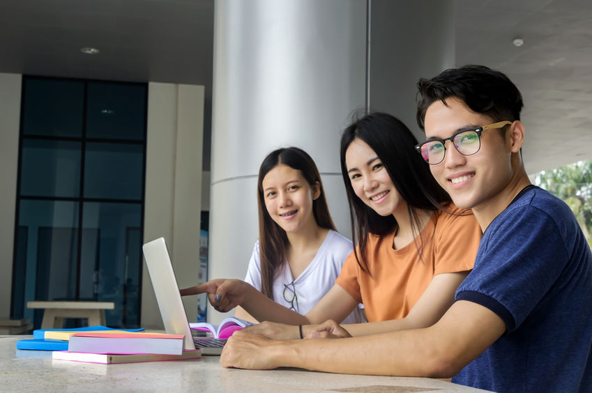 A group of college students studying together in the common area of a residence hall